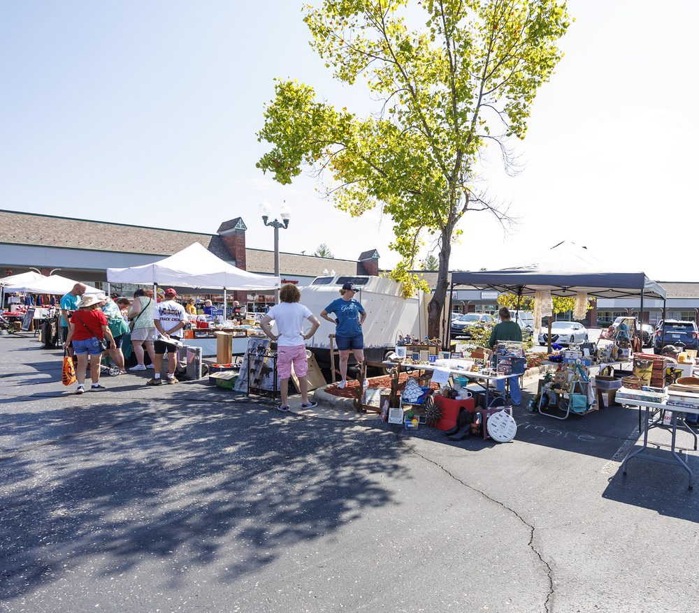 An outdoor community market and car show at the venue