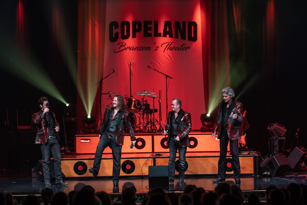 A band in sequined jackets performing on the Copeland stage