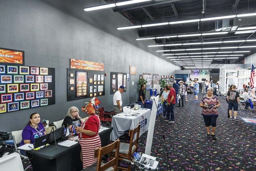 Community booths and vendor tables filling the event floor at a fundraiser